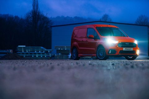 Orange Ford Transit Connect at dusk