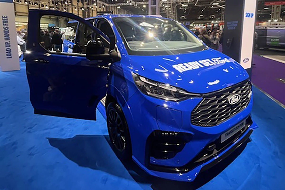 Blue Ford Transit Custom on display at the Commercial Vehicle Show 2026 with the driver door open